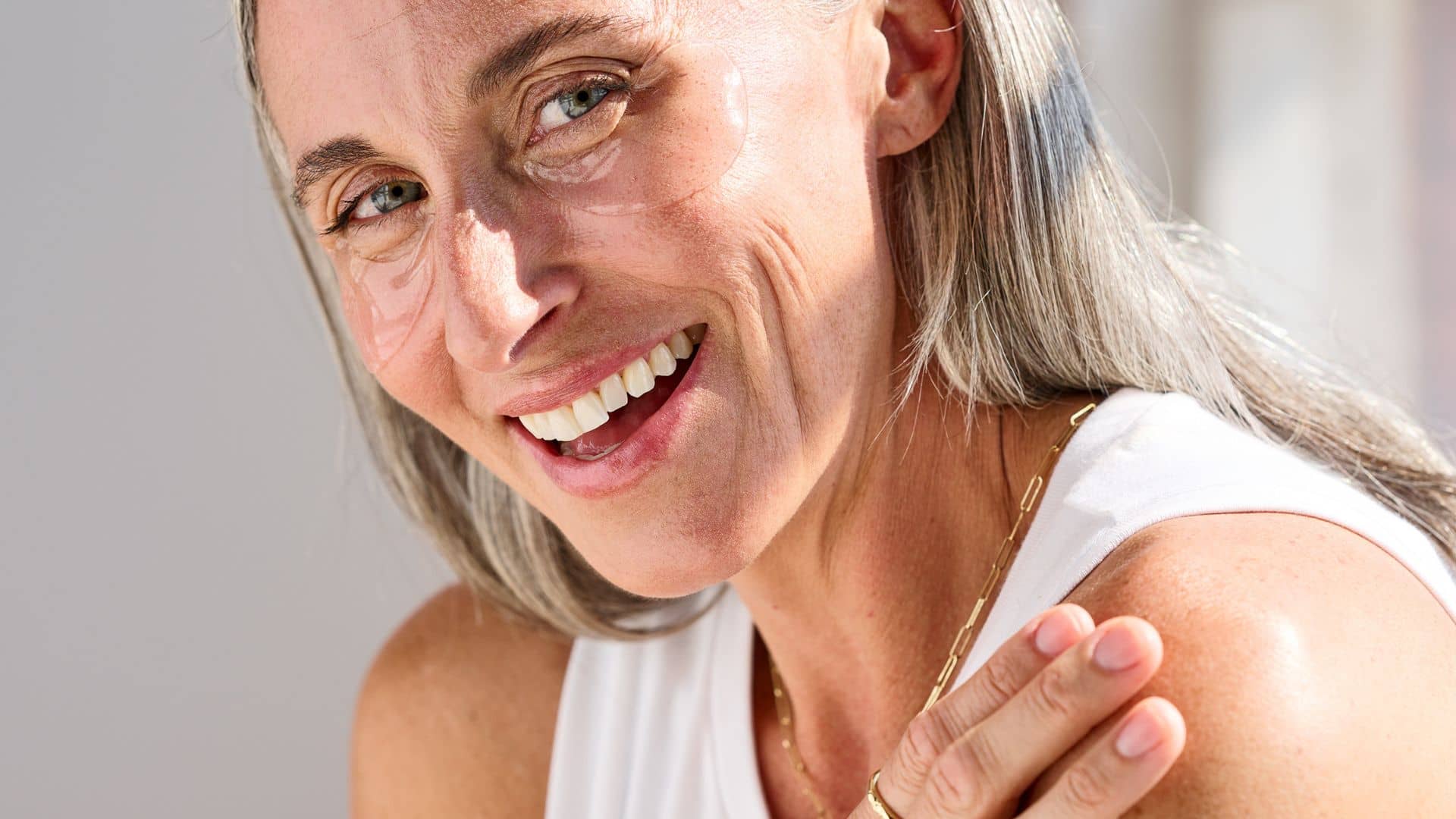woman wearing rose eye patches to hydrate and smooth under eyes