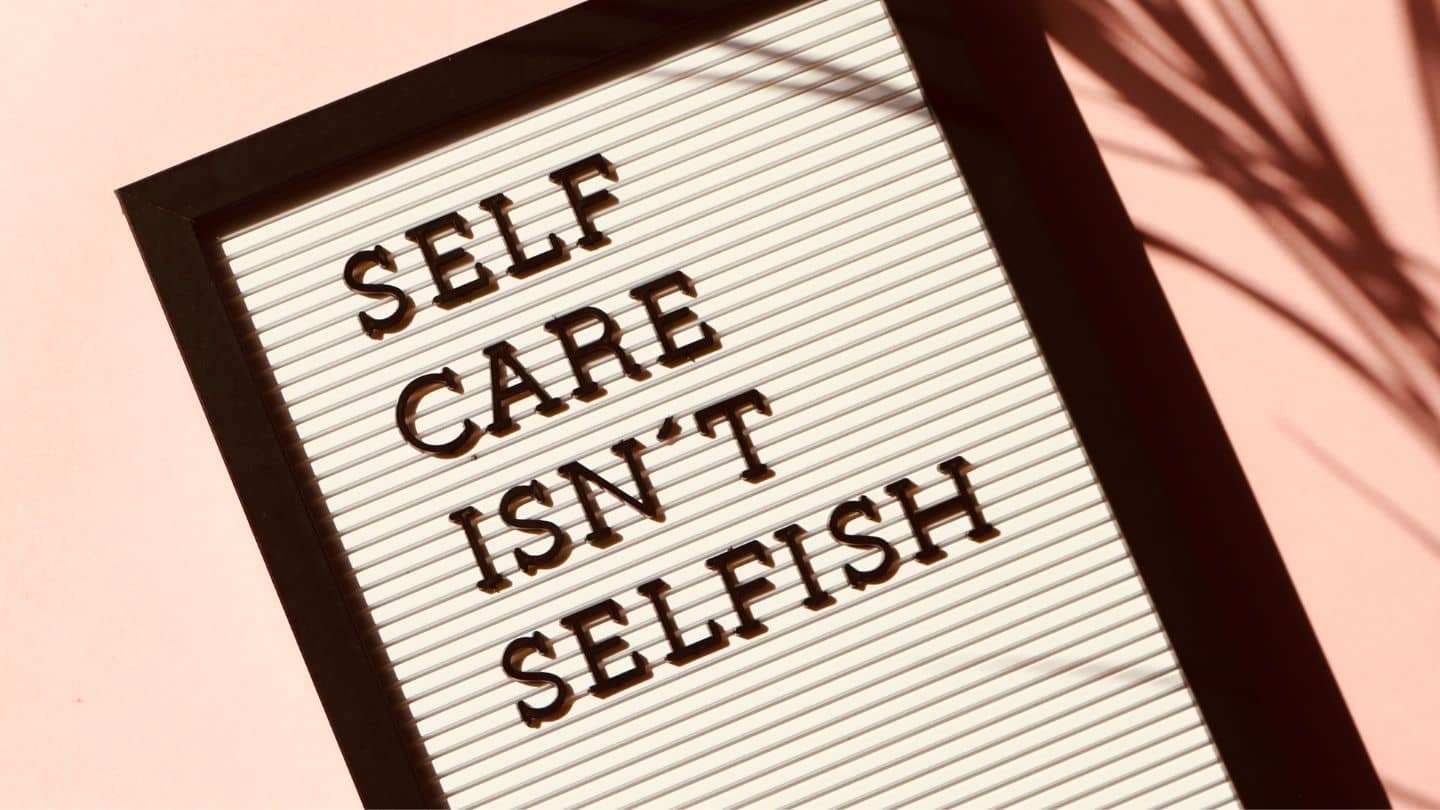 Selfcare isn't selfish sign pink background