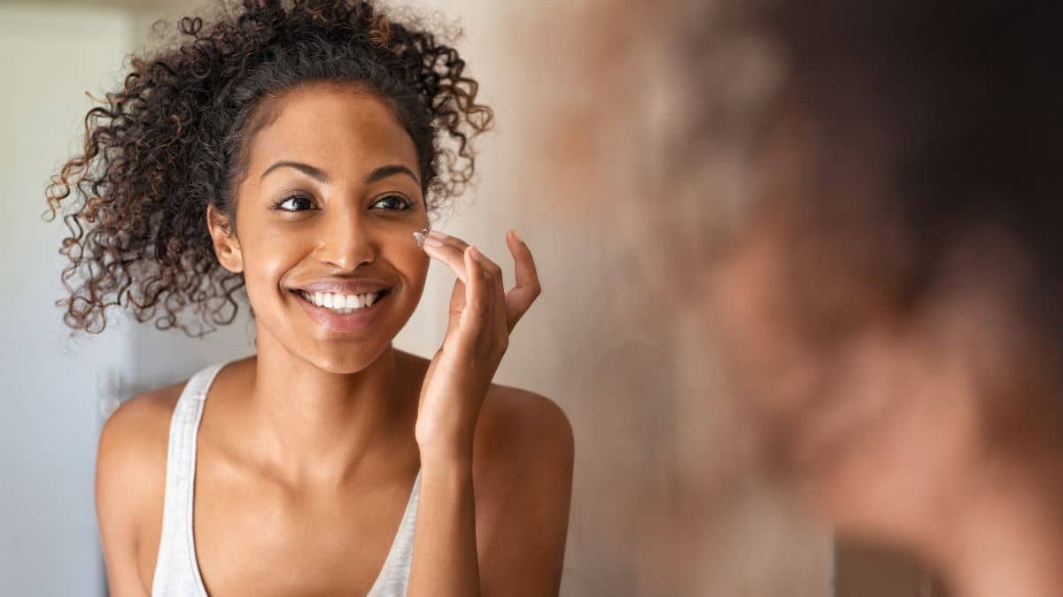 woman cleansing her face early morning acne clear skin