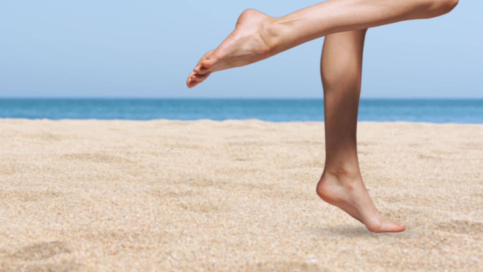 woman at the beach hydrated healthy feet