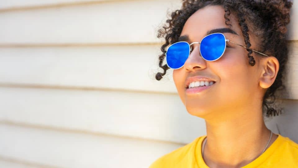 woman outside protecting lips from sunburn