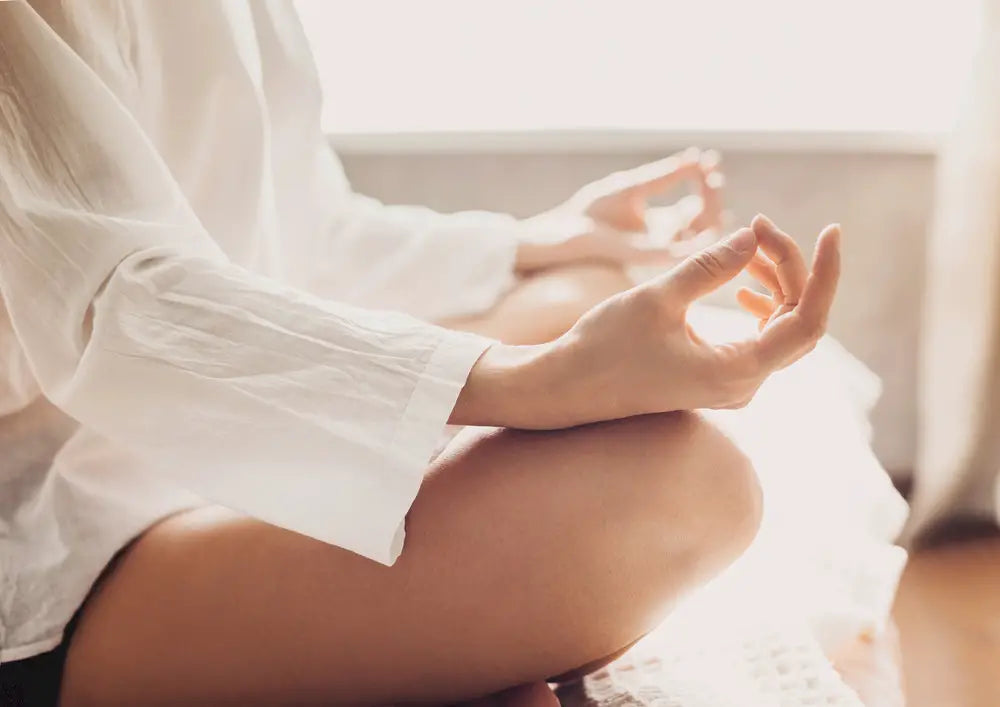 Woman meditating to reduce stress
