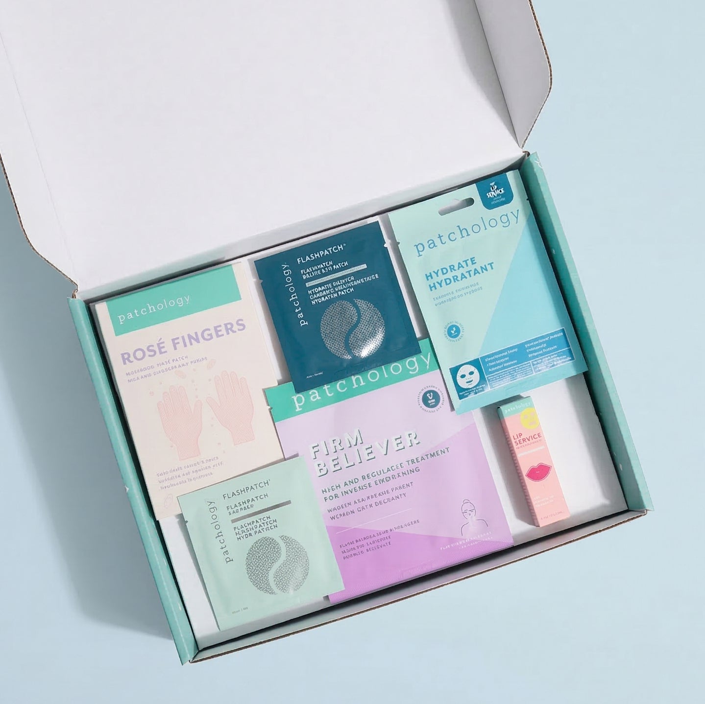 Patchology skincare product set in an open box on a light blue background