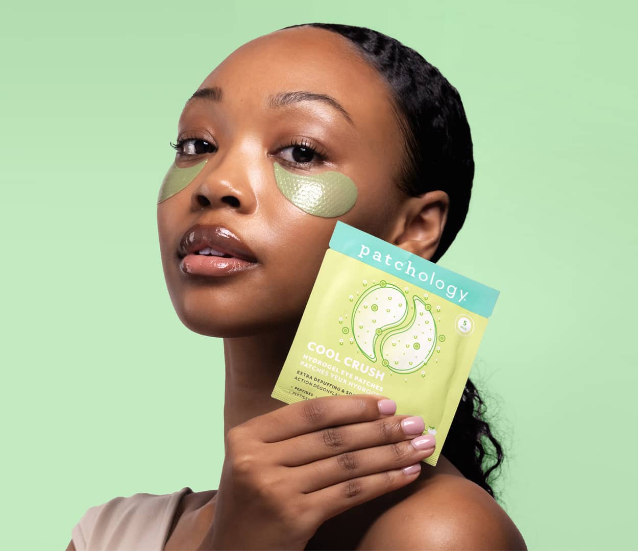 depuffing cool crush under eye gels in use on a green background