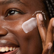 Close-up of a woman applying white air-whipped gel cream to her cheek, with her hand and part of her face visible. White text on the image reads 'air-whipped gel cream'.