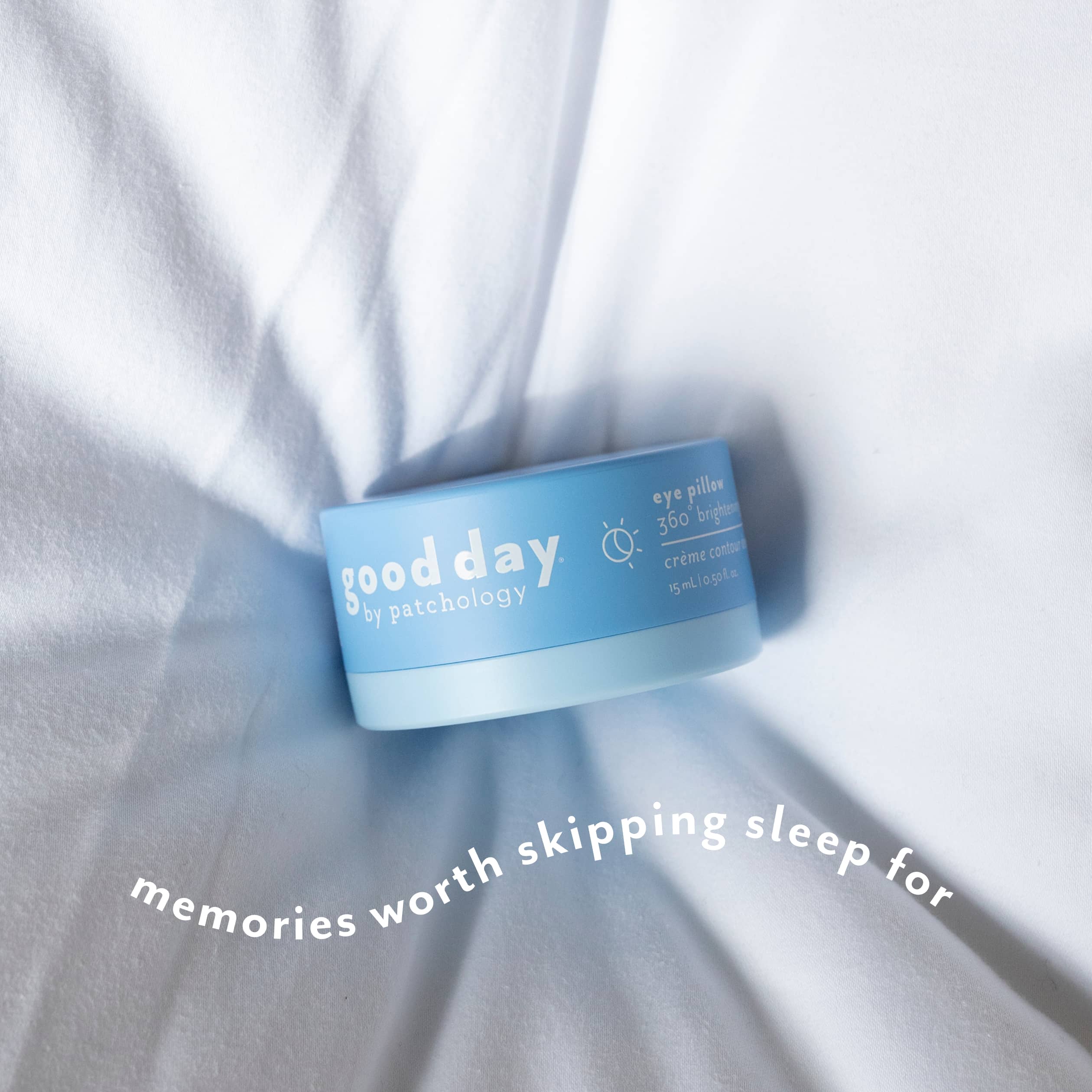 A light blue jar of Good Day eye pillow cream rests on white fabric with soft shadows. White text at the bottom reads 'memories worth skipping sleep for'.