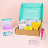 Patchology skincare kit with various products on a pink background