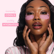 A woman with pink striped eye patches on her face, posing against a light pink background with text that reads 'instantly COOLS visibly HYDRATES'.
