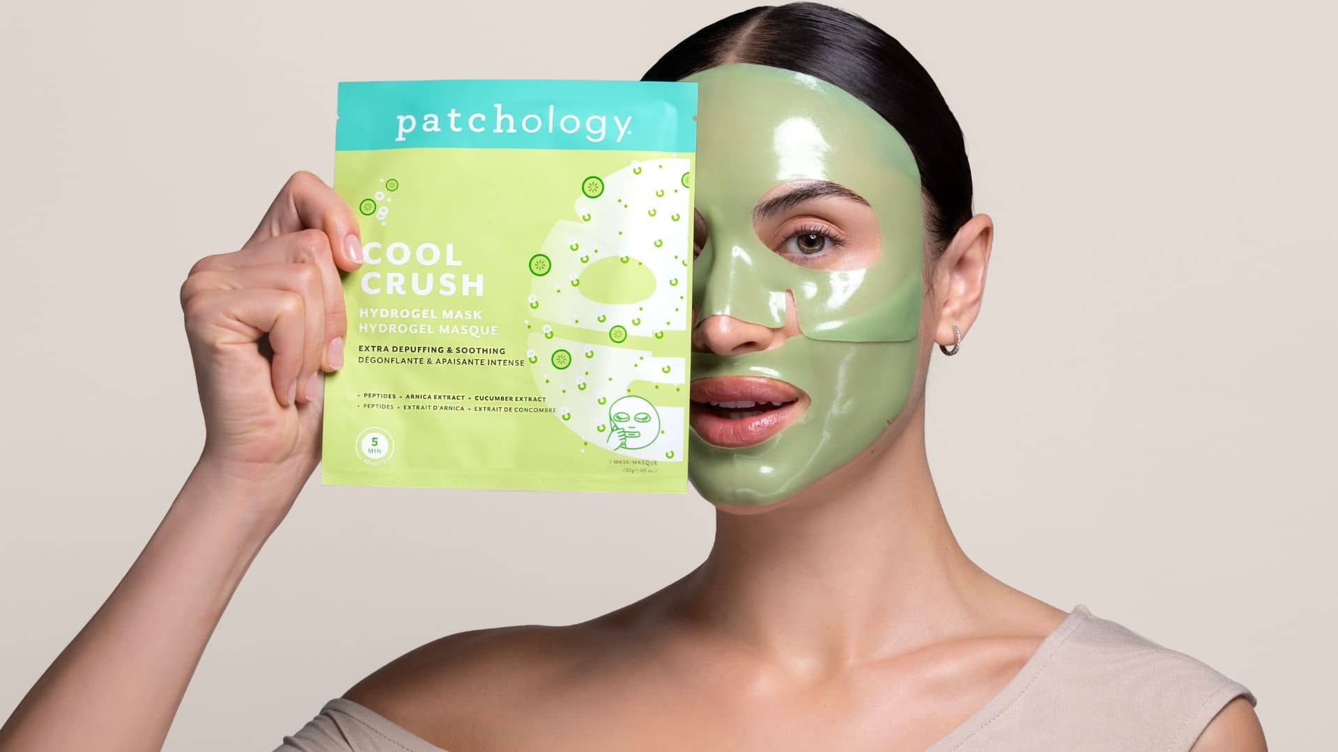 Woman wearing a green facial mask with cool crush packaging in the background