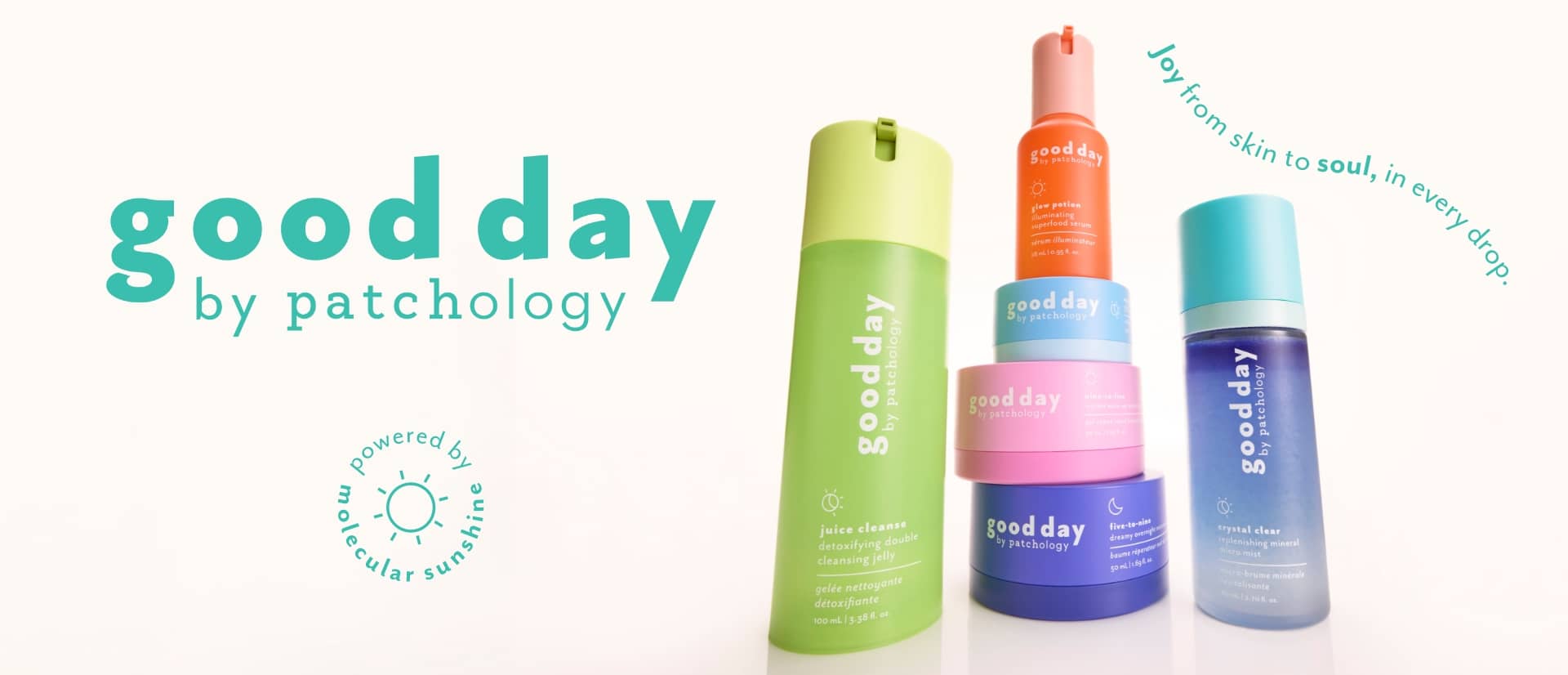 A set of Good Day by Patchology skincare products on a clean off-white background, featuring a tall light green bottle, a stacked set of orange, pink, and purple jars, and a light blue spray bottle. The brand name 'good day by patchology.