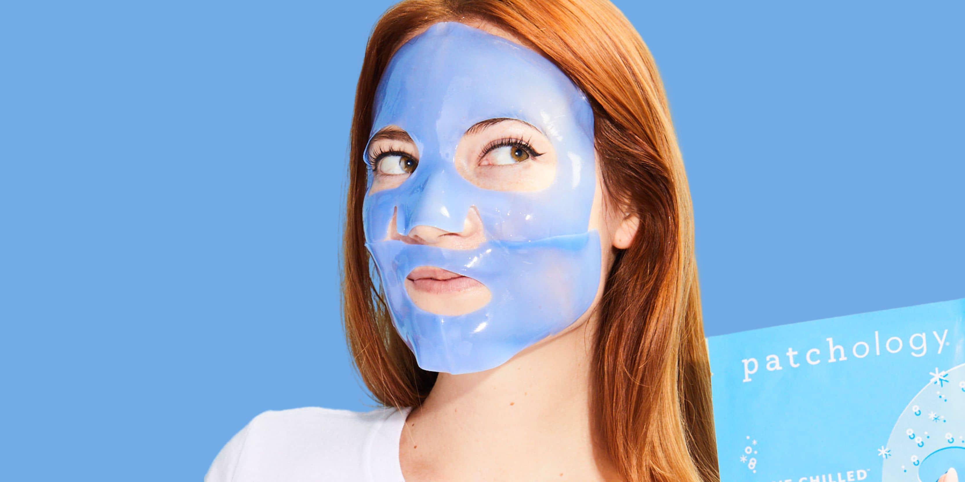 Woman wearing blue gel sheet mask on face, hydrating skincare treatment with glossy finish against blue background