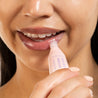 woman applying overnight lip balm to restore and heal dry cracked lips