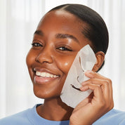 hydrate sheet mask in use close up bright light background