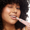 woman using lip gloss patchology clear honey smoothing dry cracked lips