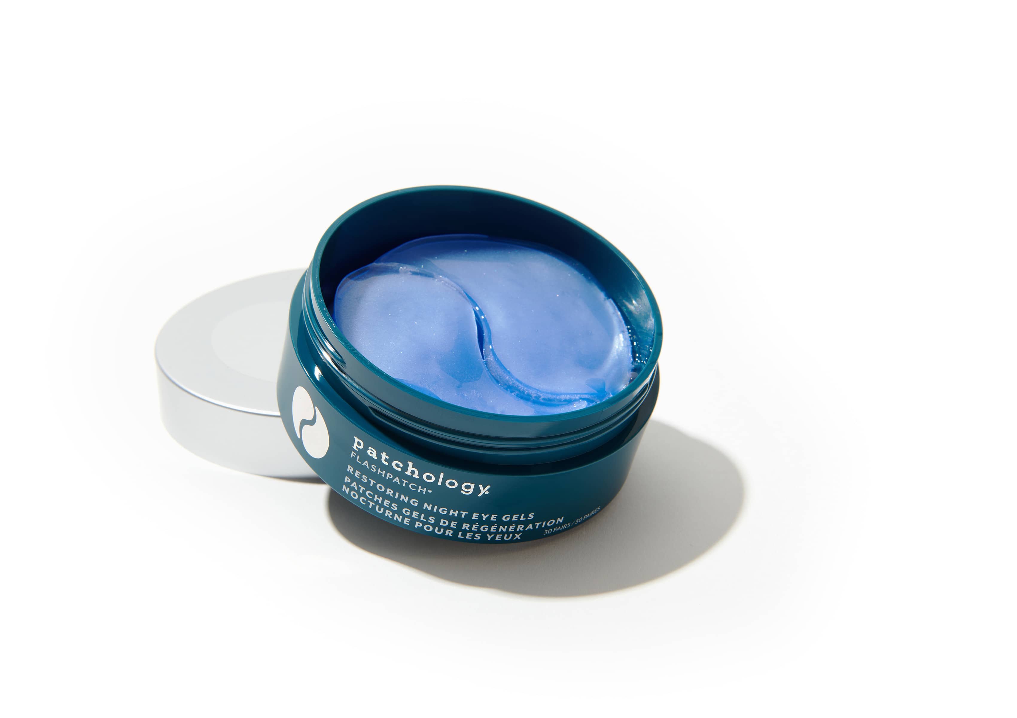 Patchology FlashPatch Restoring Night Eye Gels open blue jar with hydrogel patches on white surface for skincare use
