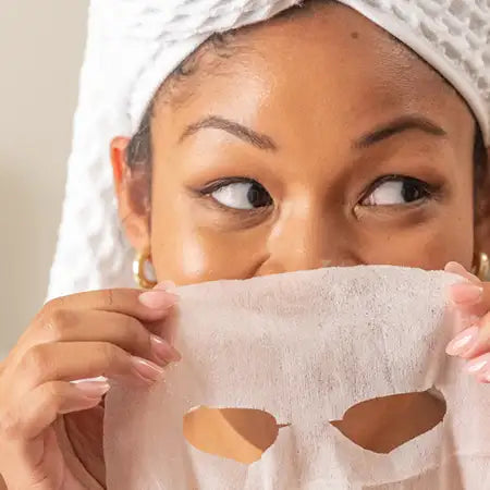 woman wearing a sheet mask illuminating patchology five minute mask