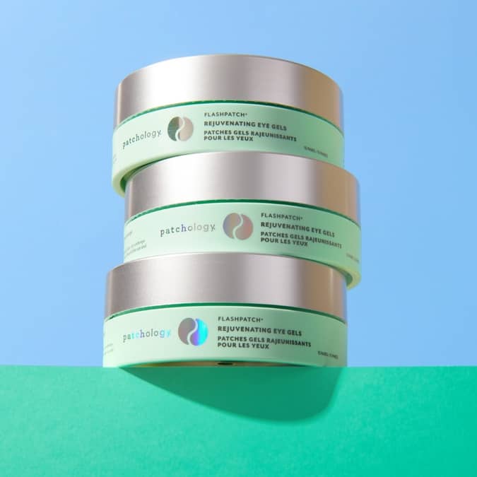 Stack of Patchology eye gel containers on a blue and green gradient background