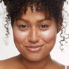 woman with brown hair wearing the rejuvenating eye gels to brighten and de-wrinkle under-eyes