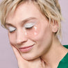 Woman with light hair wearing rosé eye gels