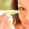 woman applying roll model eye serum depuff and hydrate eyes