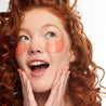woman with red hair wearing Happy Place eye gels