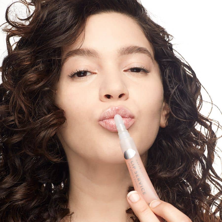 woman using lip service hydrating honey vitamins gloss to balm healing cracked lips